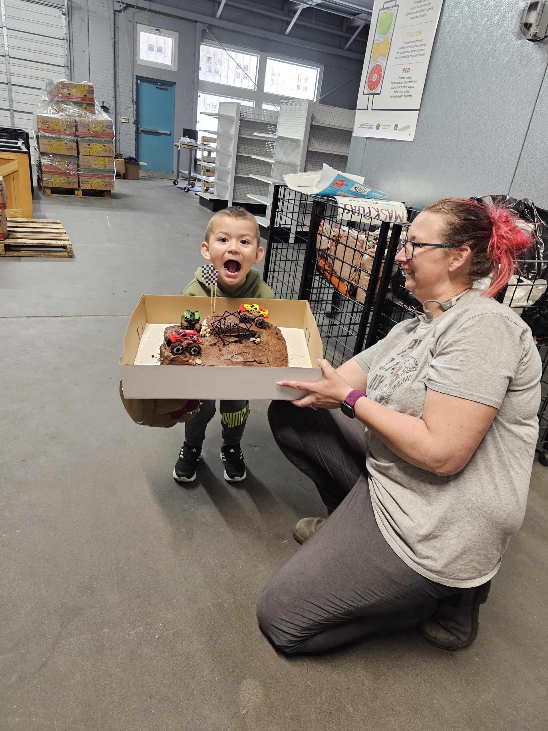 Woman helps child open birthday cake